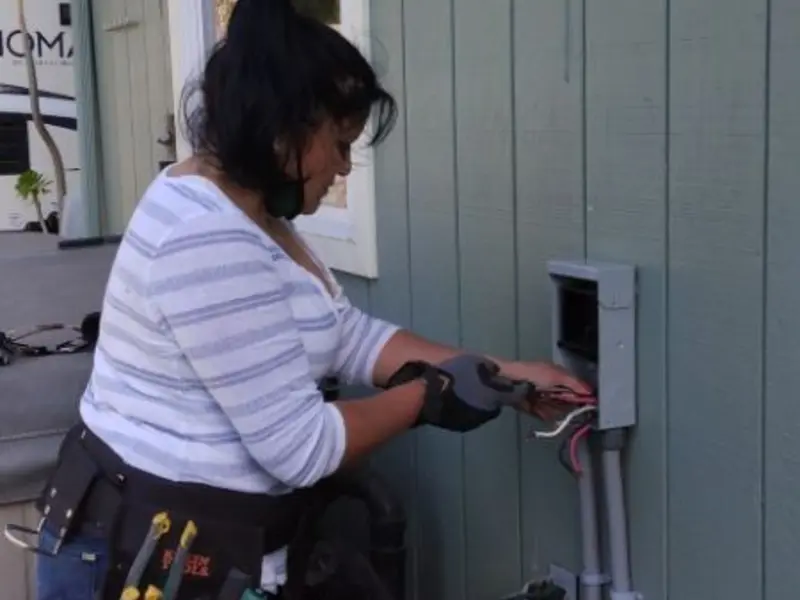 Licensed electrician wiring an exterior subpanel in Athens